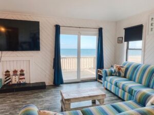 Living room in oceanfront Outer Banks beach house rental with ocean and beach views